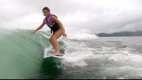        a young lady wakesurfs on lake arenal
  - Costa Rica