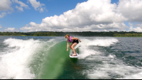        a woman wakesurfing on a sunny day on lake arenal
  - Costa Rica