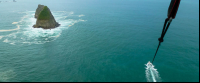        parasailing in the air 
  - Costa Rica