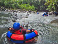        Kid On An Inner Tube Floating Toward The Currents Blue River Rincon De La Vieja
  - Costa Rica