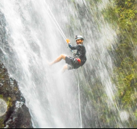        Man Smiling While Rappelling Down Horseback Rapelling Tour Rancho Tropical Matapalo
  - Costa Rica