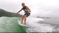        a man wakesurfs on lake arenal in the morning
  - Costa Rica