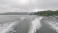        a man wakeboards jumping in the air above lake arenal on a foggy morning
  - Costa Rica