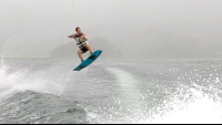        a man up in the air wakeboarding on lake arenal
  - Costa Rica