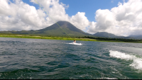        a man starting to wakeboard on lake arenal
  - Costa Rica