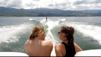        friends watching a third one waterskiing on lake arenal
  - Costa Rica