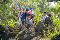       group of tourist taking pictures of the lava molten rocks at  hiking trail
  - Costa Rica