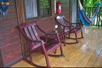        One King Bed Cabanas Corridor With Two Chairs And A Hammock Blue River Resort
  - Costa Rica