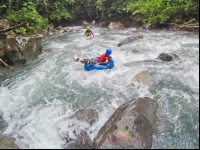        Lady Tubing On The Rocky Rapids Of Blue River Rincon De La Vieja
  - Costa Rica