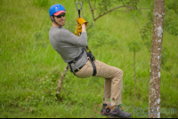        Man Riding A Cable On Blue River Zipline Rincon De La Vieja
  - Costa Rica