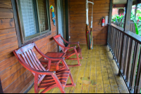        Two Queen Bed Cabanas Front Corridor With Chairs And Hammock Blue River Resort
  - Costa Rica