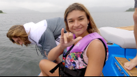        lady smiles to the camera as she prepares for jumping in the lake
  - Costa Rica